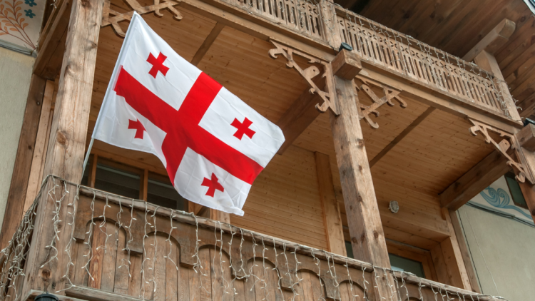 Bild einer georgischen Flagge vor einem Haus